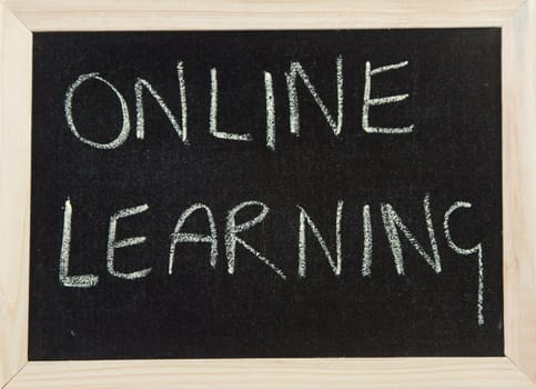 A black board with a wooden frame and the word 'ONLINE LEARNING' written in chalk.