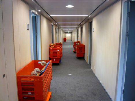 Office corridor with red removal crates