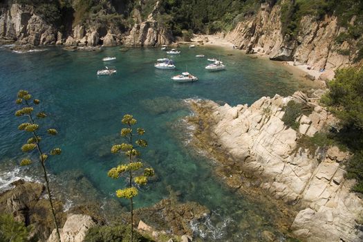 Embarcations on a Spanish Mediterranean cove. People enjoying the summer vacations.