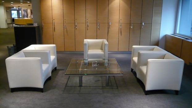 Office meeting point with chairs and table with a locker wall