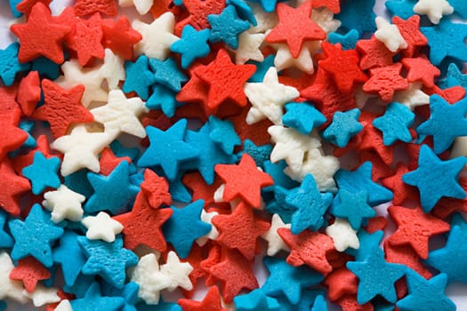 Confectionery ornament in the form of blue, red and white stars close up
