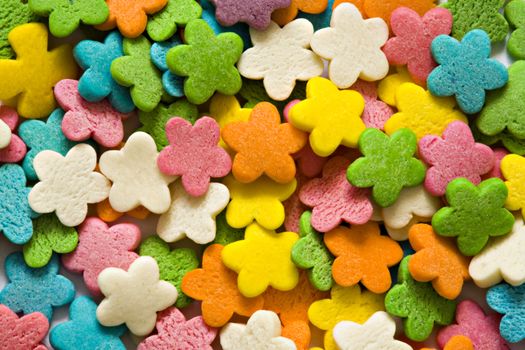 Confectionery ornaments in the form of multi-coloured florets close up
