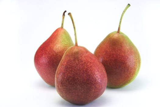 Three juicy red pears on white