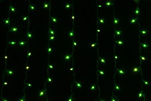 green curtain lights isolated on black background
