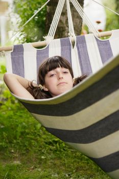 The girl lays in a hammock