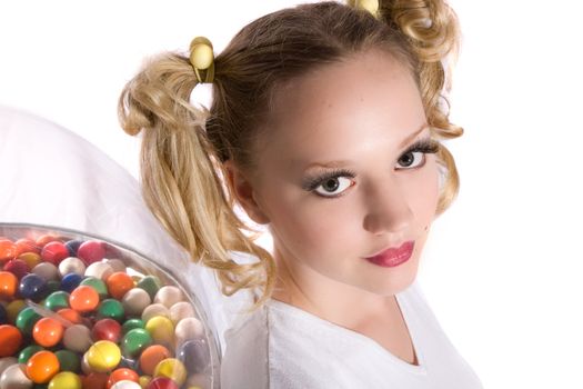 Pretty blond girl with ponytails standing in front of a bubblegum machine