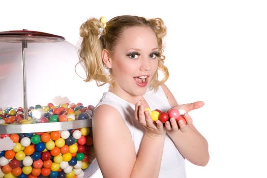 Cute young girl holding a bunch of chewing gum balls in her hands