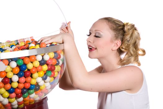 Pretty blond girl with ponytails reaching into the bubblegum container