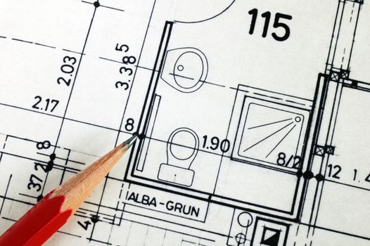 Close up detail of architect's plans for a house showing the layout of the bathroom. Architect's pencil, from bottom left, indicating a detail.