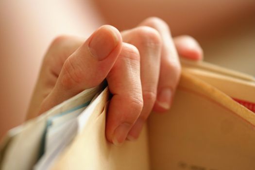 Young woman hand holding a paper document