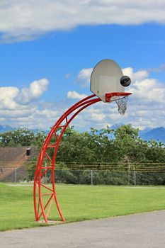 basketball hoop and sky and grass green