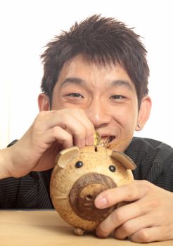 asia man with piggy bank 