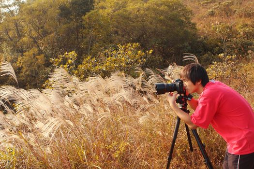 photographer taking photo in country side 