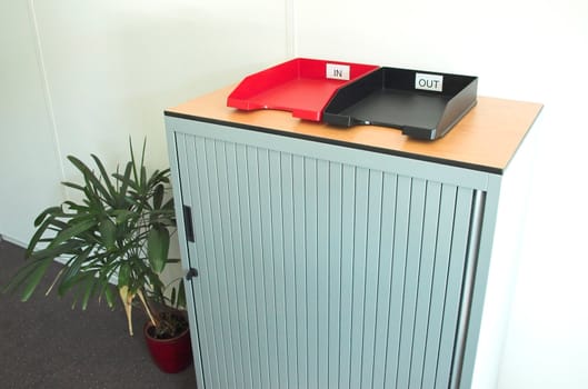 Internal mail trays on a cupboard in an office