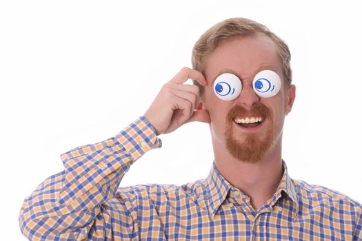 Very funny young man with toys on his eyes