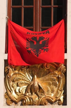 Kosovian flag hanging in a window on the day of proclamation of independence