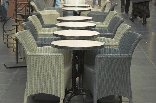 A row of coffee tables in a small cafe in the royal passage in Brussels