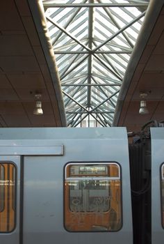 Detail of a metro train with a silhouette of a metro station roof