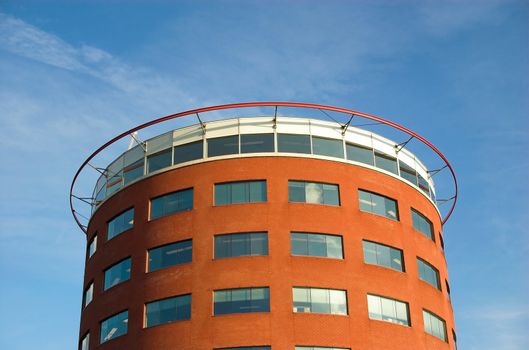 Modern round-shaped office building made of red brick and glass in Hoogvliet, Holland