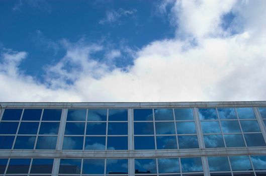 Detail of an office building facade with blue windows