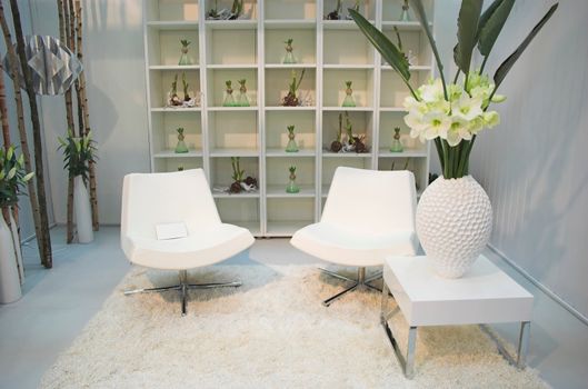 Living room arranged with modern furniture and flowers