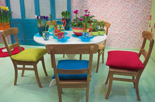 Modern dining room arranged with flowers in various colors