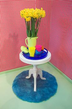 Interior detail arranged in bright and colorful modern style with flowers