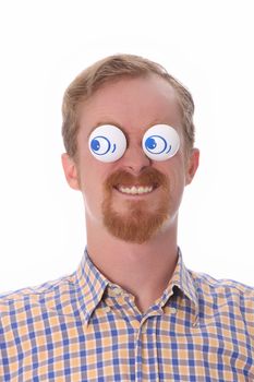 Very funny young man with toys on his eyes
