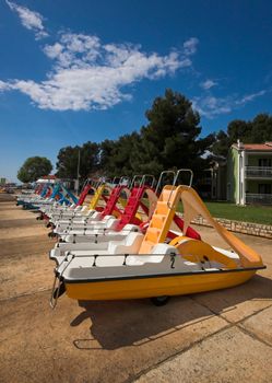 Water bicycles rowed at the edge of a sea