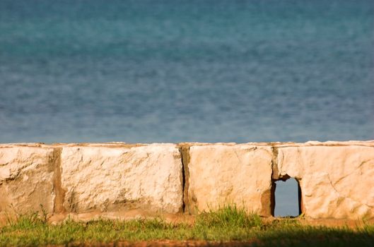 Stony wall with a sea in the background