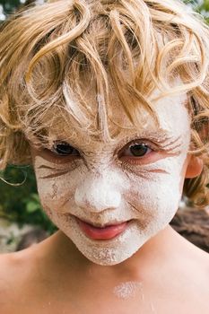 Young boy after sticking his face in a bowl of flour.