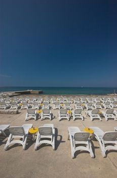 Plastic beach chair at the edge of a sea