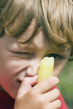 A boy with a cool ice block on a hot day