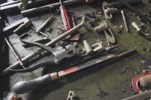 A scattering of tools on a toolbench in an old shed