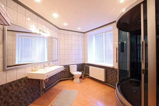 

Modern bathroom with a mirror, a bowl and a convenient per capita booth