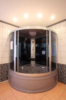 

Modern bathroom with a mirror, a bowl and a convenient per capita booth