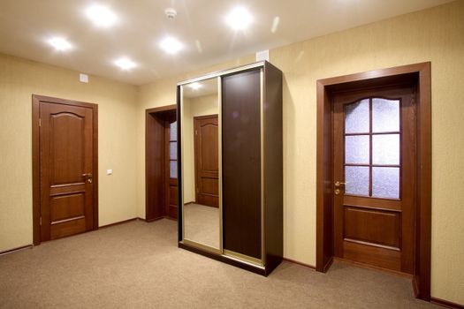 Spacious corridor with a case-compartment and three doors