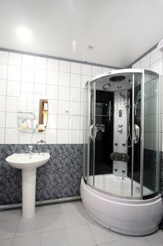 

Modern bathroom with a mirror, a bowl and a convenient per capita booth