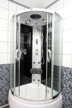 

Modern bathroom with a mirror, a bowl and a convenient per capita booth