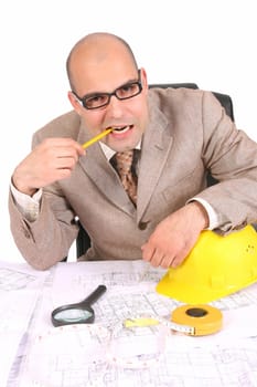 Businessman thinking with architectural plans on white background