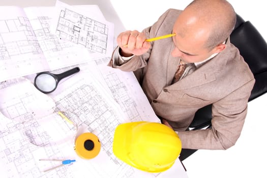 Businessman thinking with architectural plans on white background