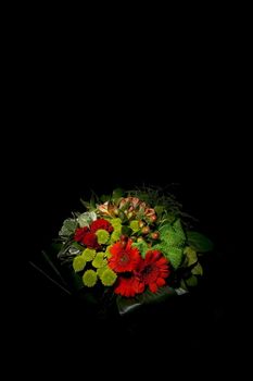 Red flowers bouquet isolated on black with selective lighting