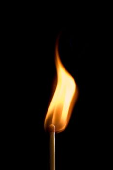 single match on fire isolated on black background