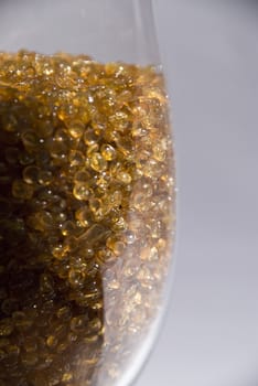 glass cup with decoration of some small stones that look like amber or something to eat
