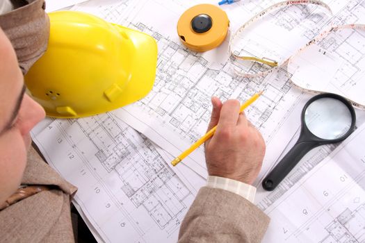 A Businessman working with architectural plans