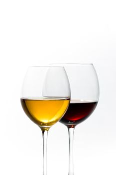 Two tall glasses isolated on white filled with red and white wine