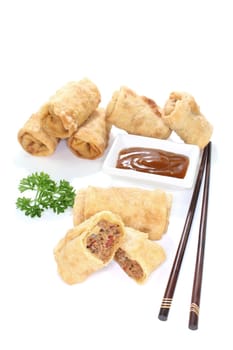 Spring rolls with ground beef, tomatoes, parsley and garlic on a white background