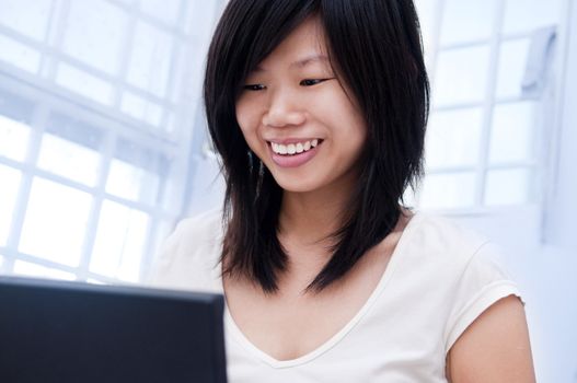 Happy Asian women using internet with smiling face.