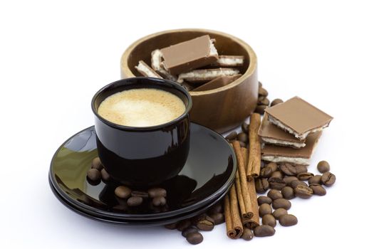cup of italian espresso with cinnamon, coffee beans and chocolate