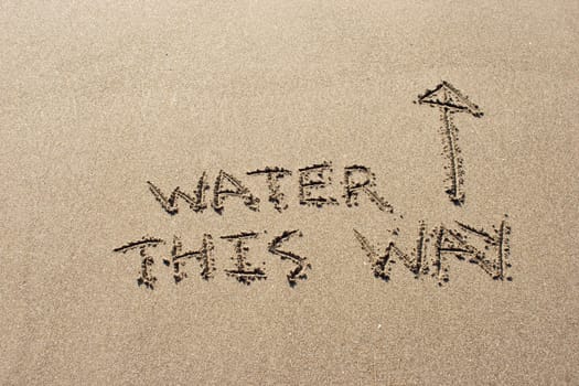 Water this way written in the sand at Haumoana Beach, Hawke's Bay, New Zealand